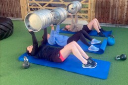 Using barrels in exercises in outdoor area at Halton Gym